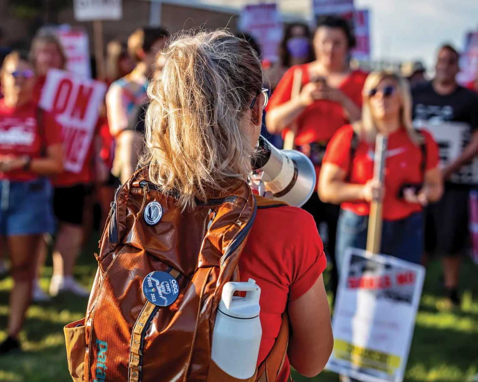 Activist speaking through a bullhorn at a rally.