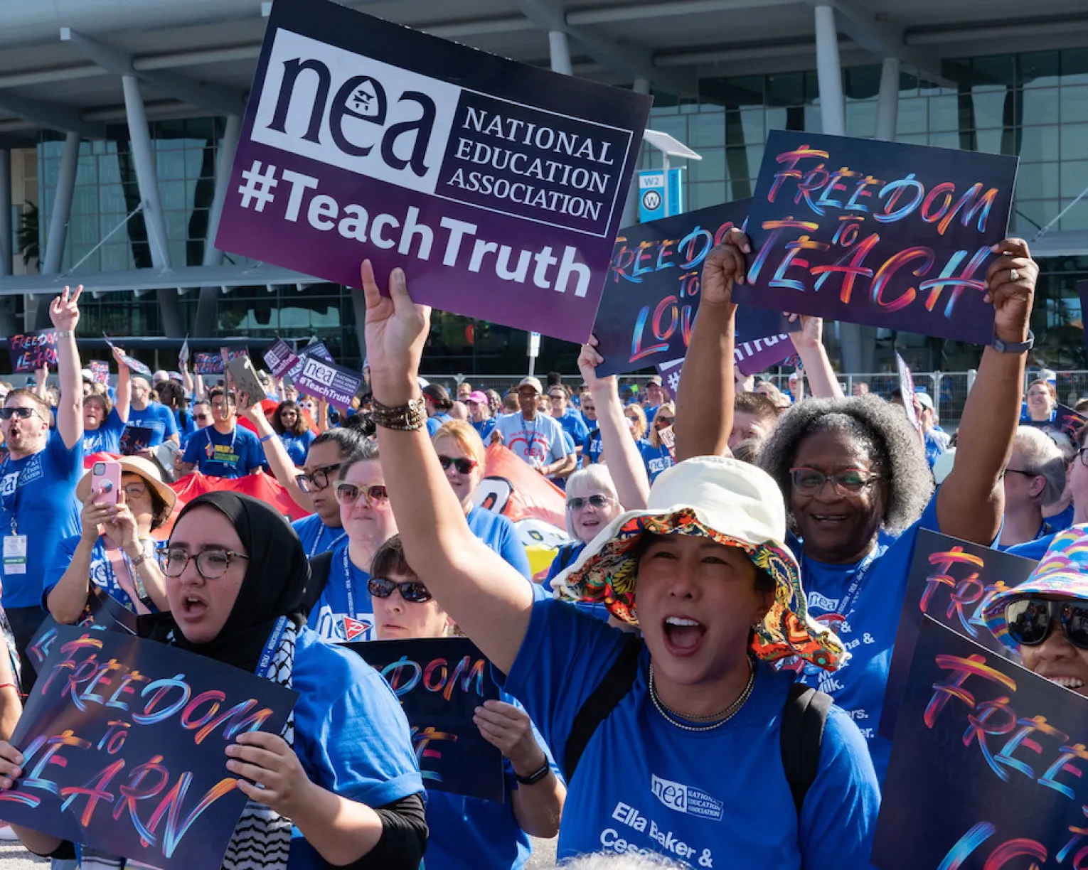 Educators hold Freedom to Teach signs at rally in Orlando