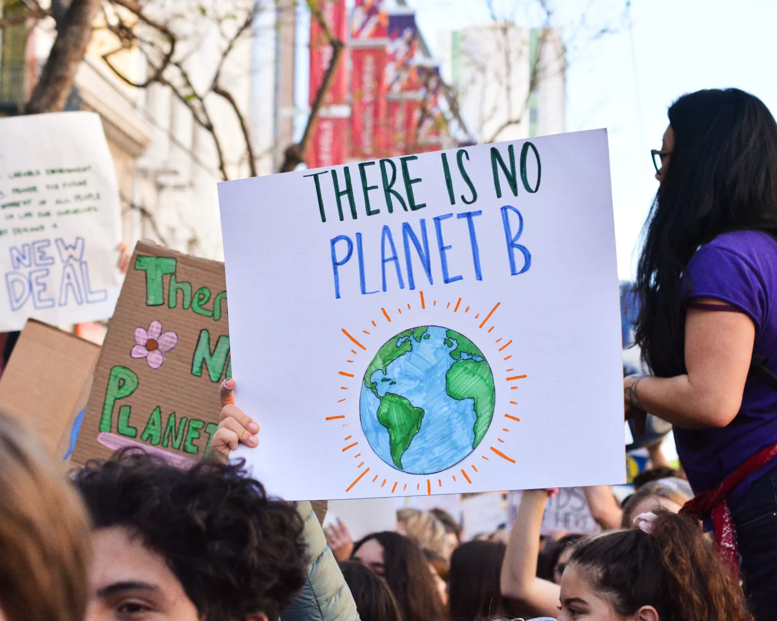 Activist holding a sign that reads, "There is No Planet B"