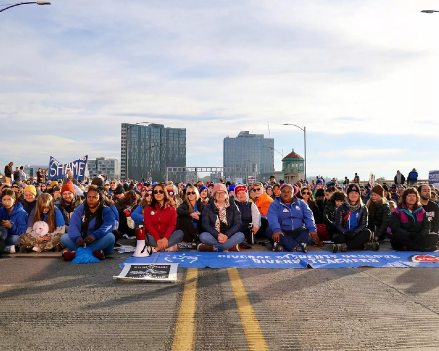 Educators and allies in Portland sit together to shut down a bridge and demand investment in public schools.