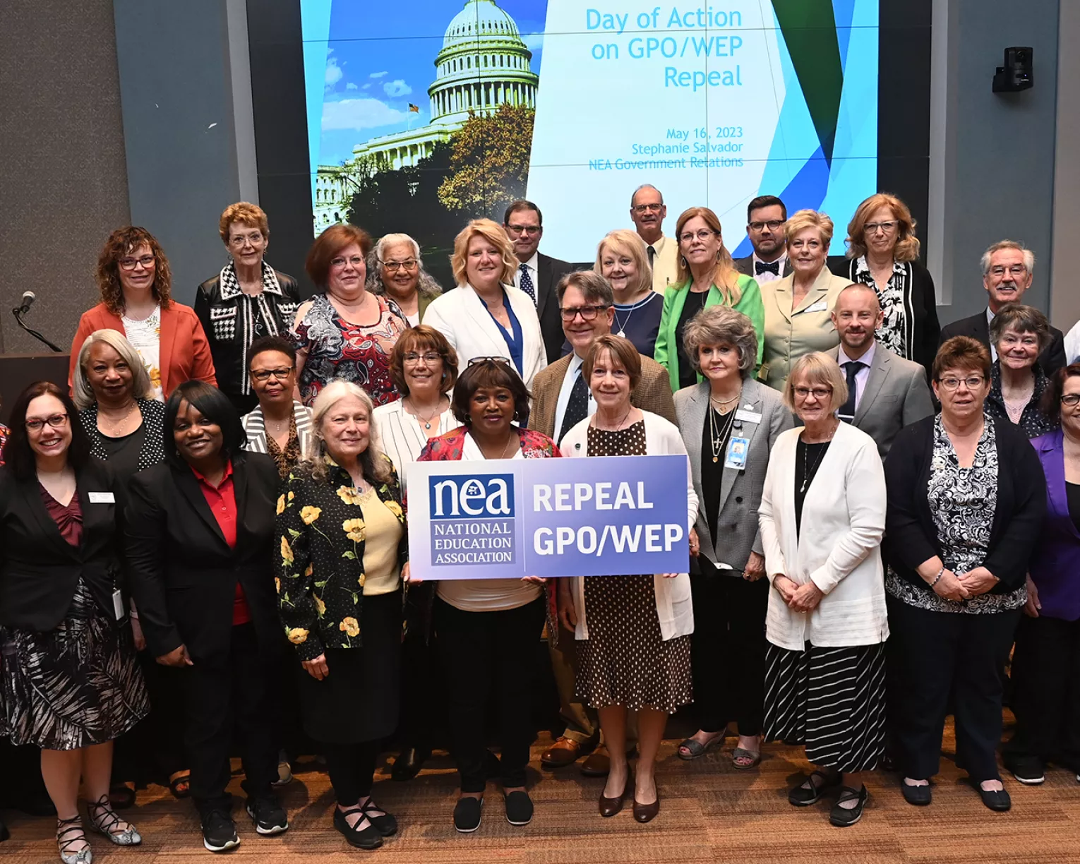 NEA members pose as a group with a sign that says repeal GPO/WEP