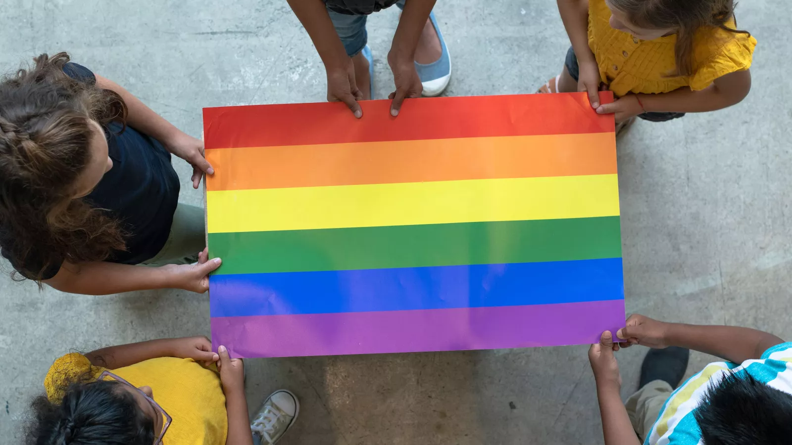 Children hold a Pride flag
