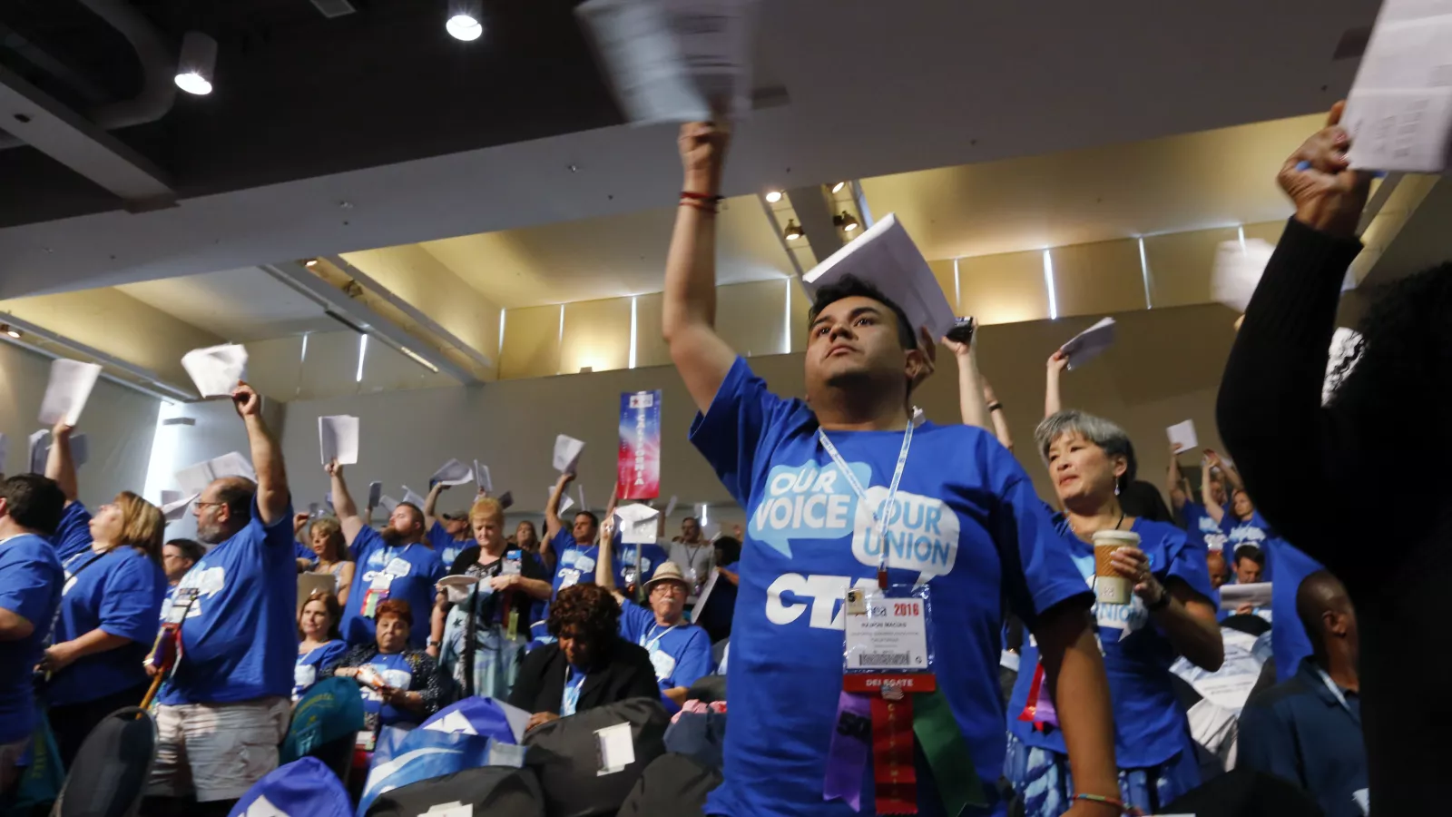 California NEA members vote in their caucus meeting
