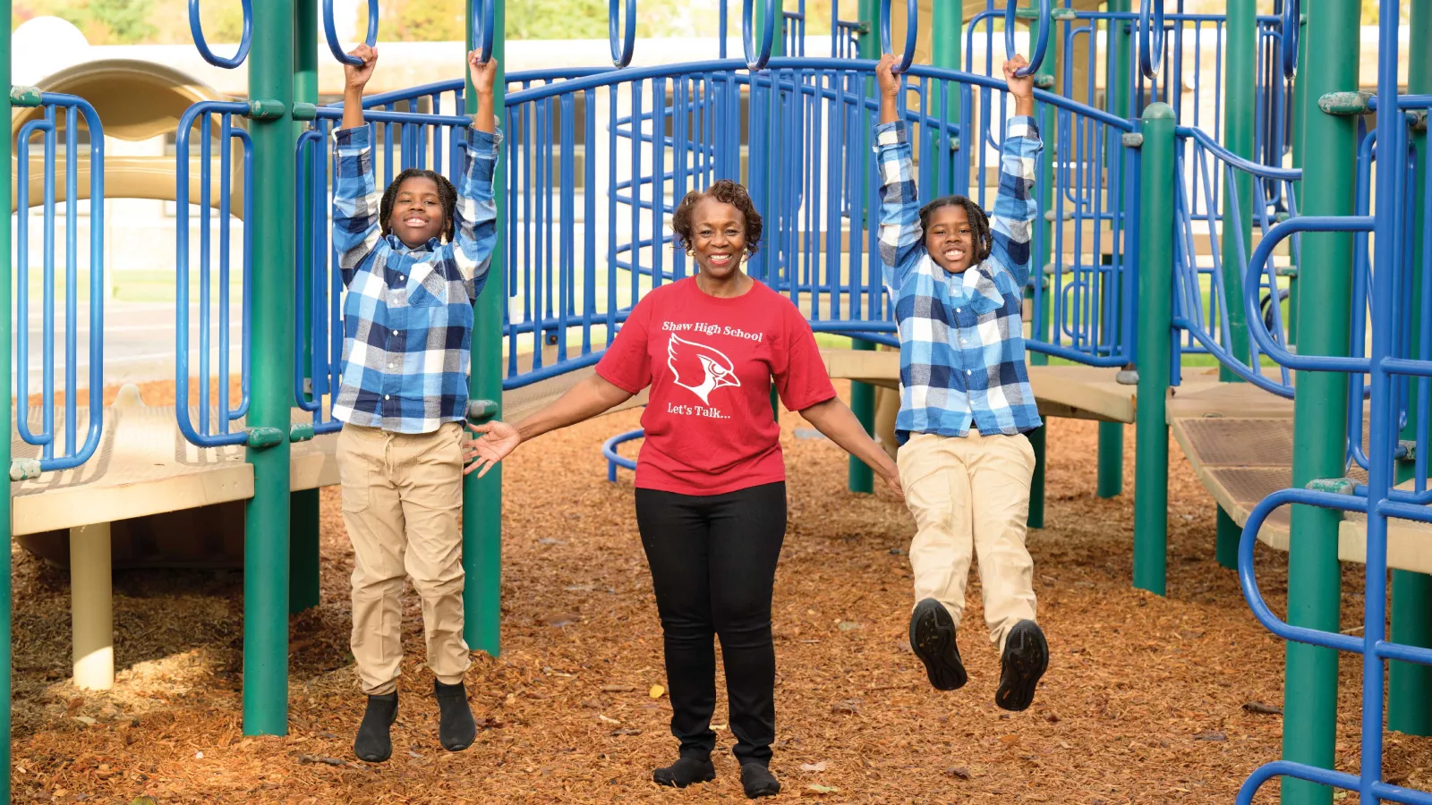 NEA-Retired member Valenta Ward-Gravely with her 10-year-old grandsons, Christian and Caiden at the school playground.