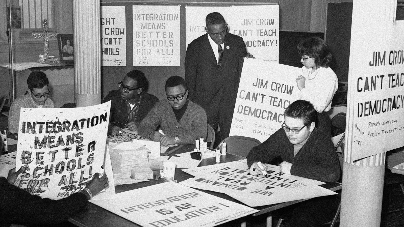 Black and white image of a group of men and woman preparing boycott signs.