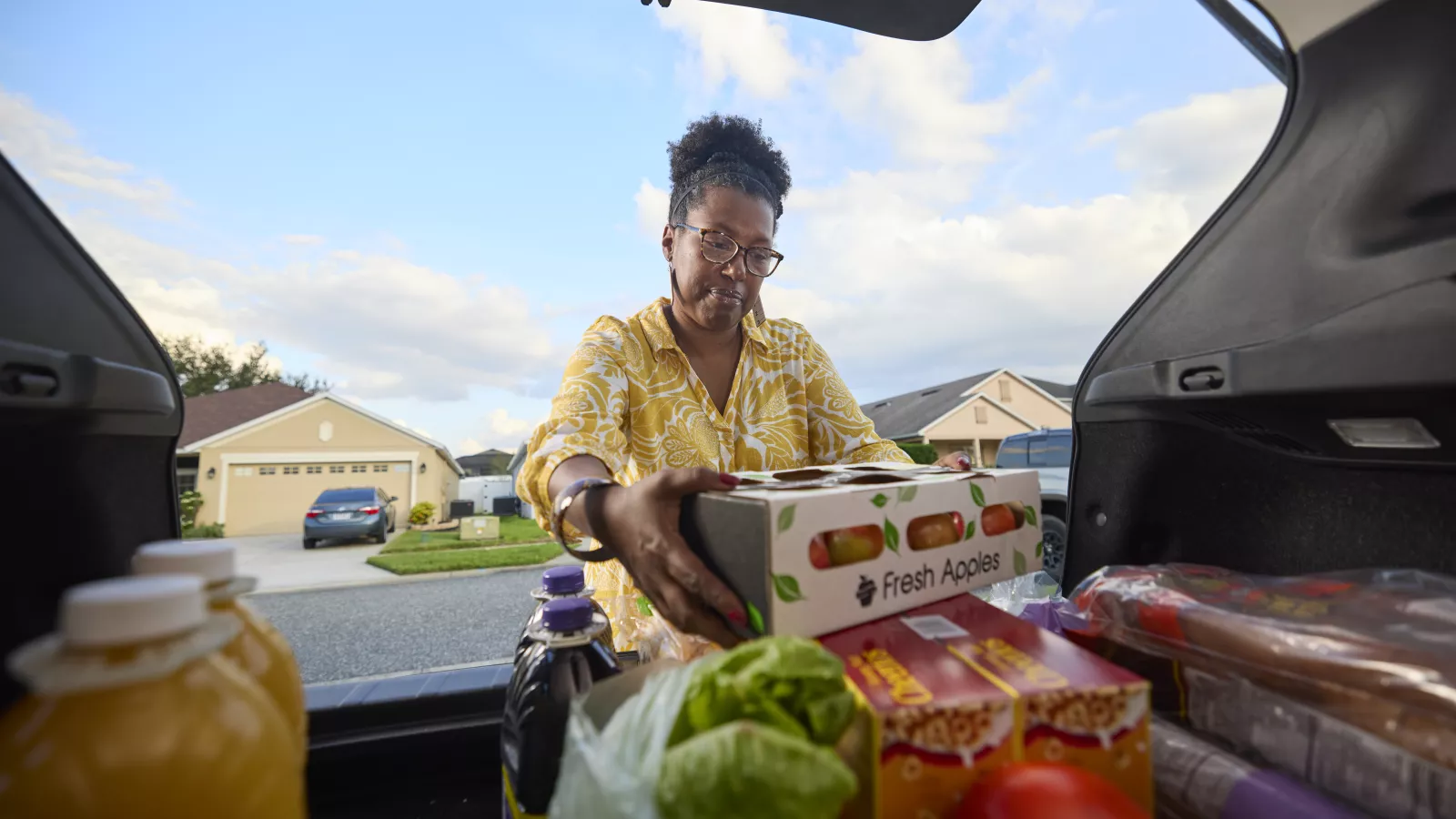 Tamara Russell unloading groceries from her car