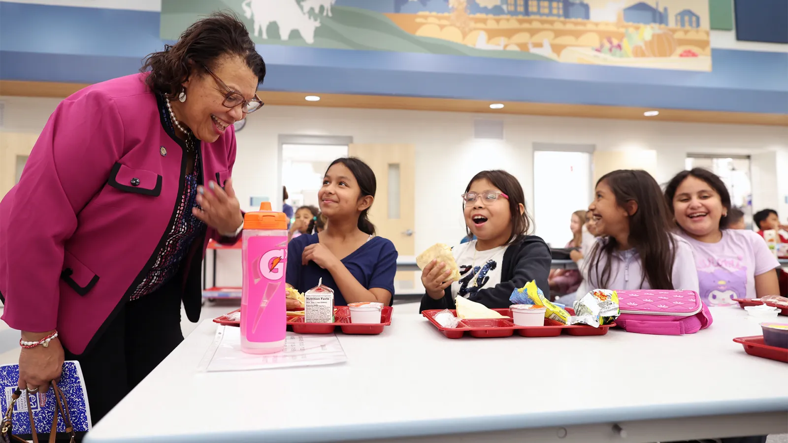 NEA President Princess Moss talks with female students in the school cafeteria