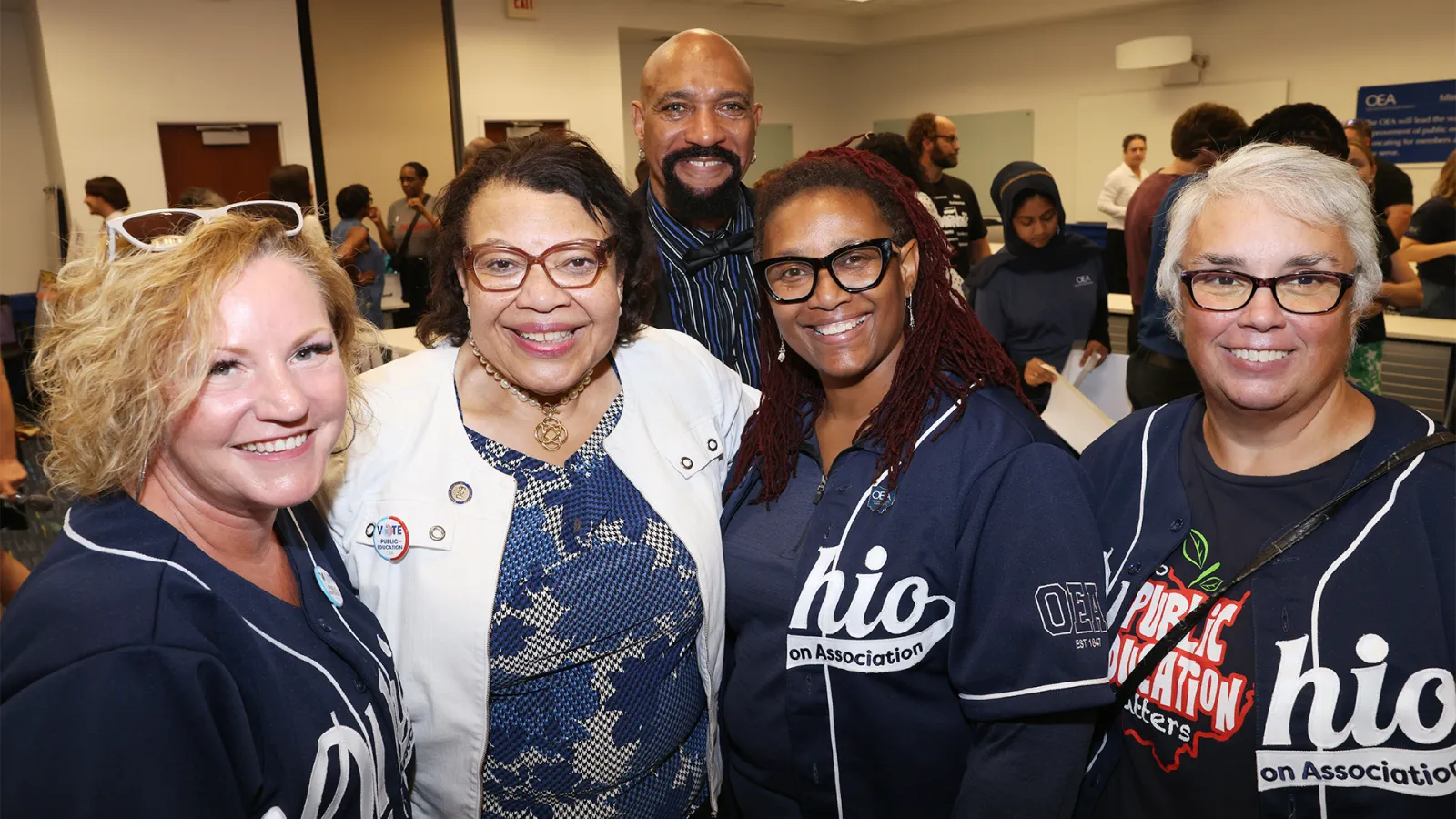 Princess Moss poses with Ohio NEA members in Ohio baseball shirts