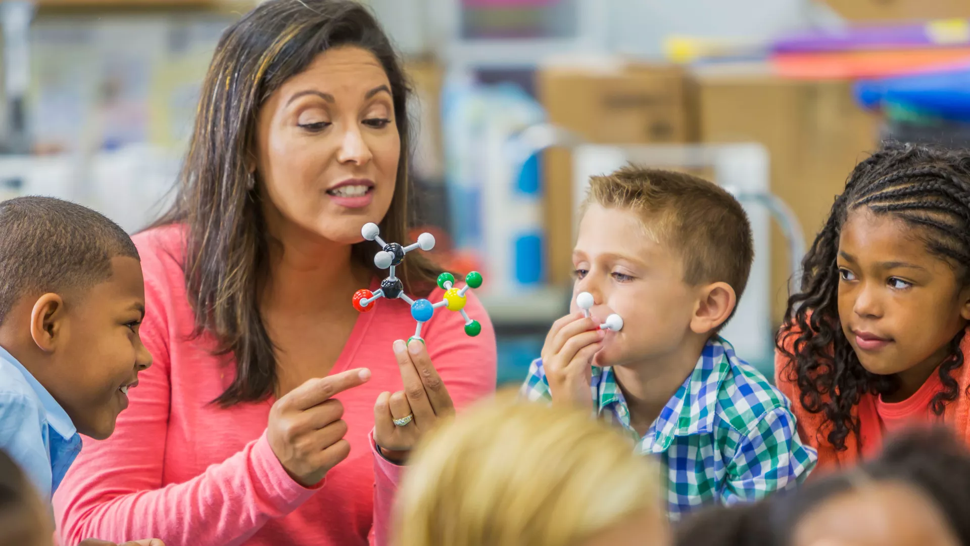 Educator teaching science lesson to young students