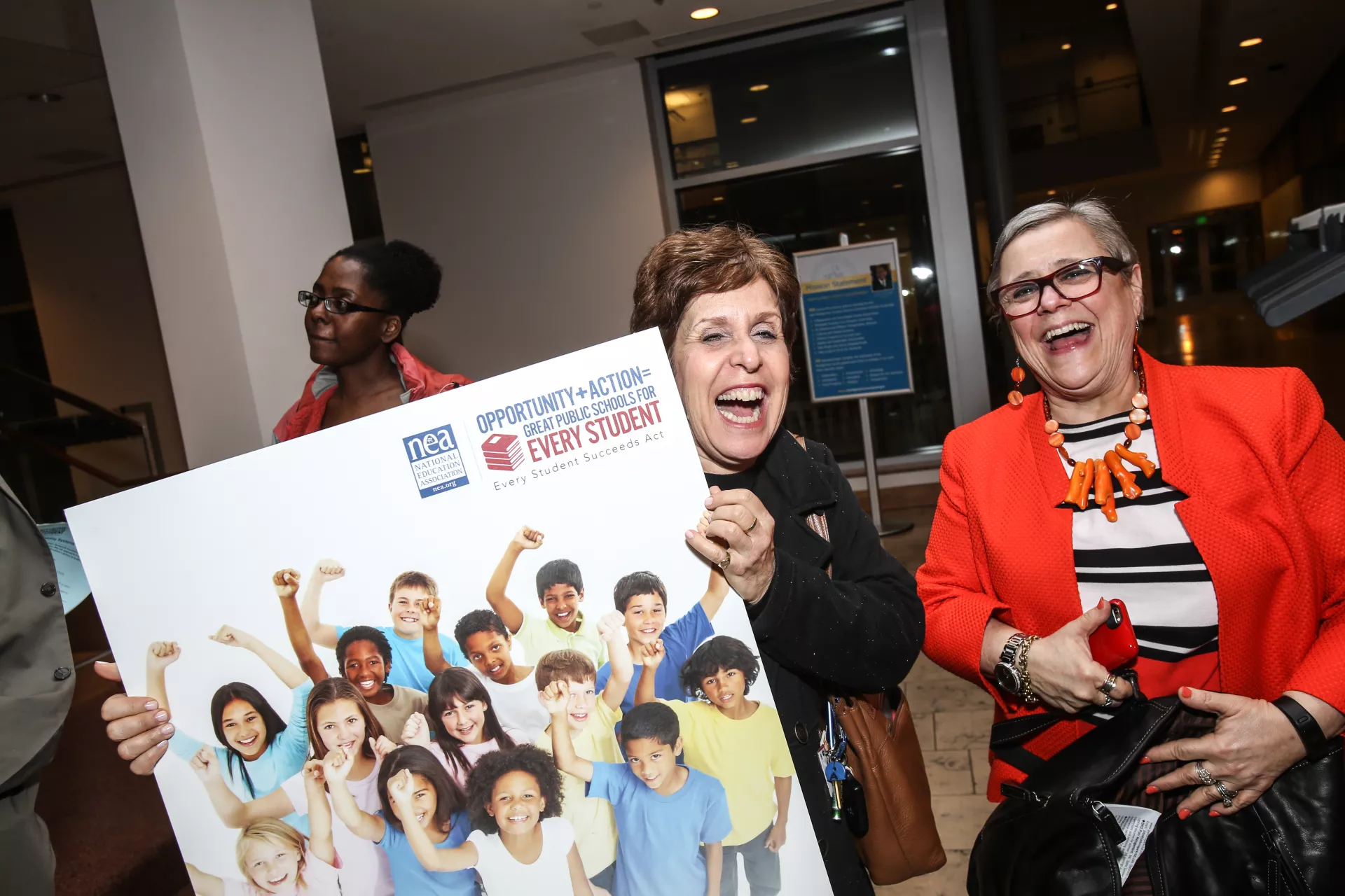 NEA members with ESSA sign