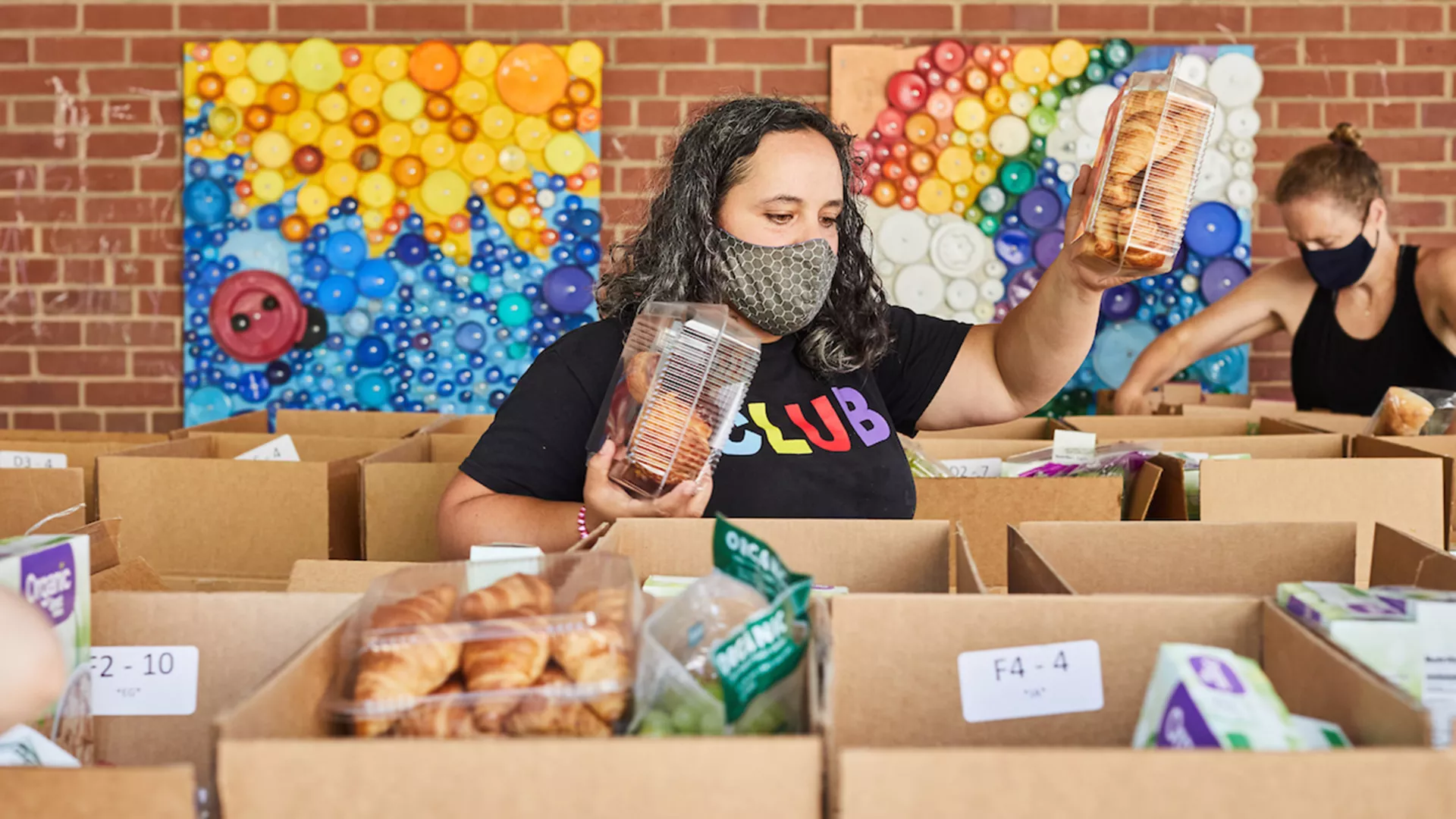 Megan McCurley and Becky Sanford-DeRousie load boxes of food for families