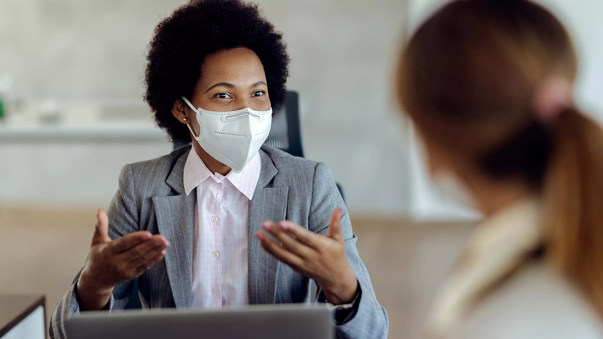 Colleagues meet while wearing masks