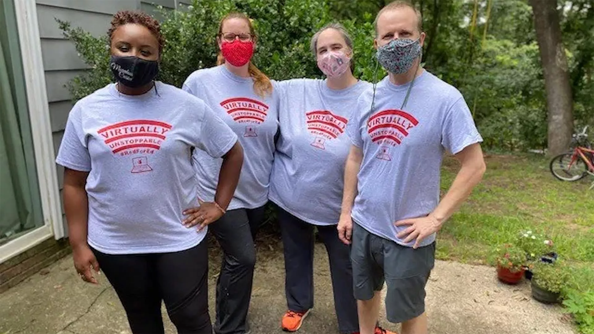 Four teachers pose in #RedForEd T-shirts