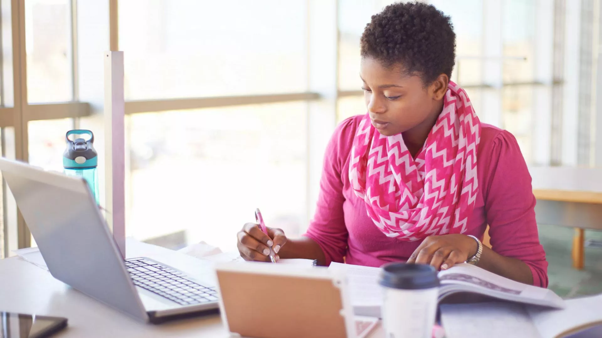 A woman studies using a laptop