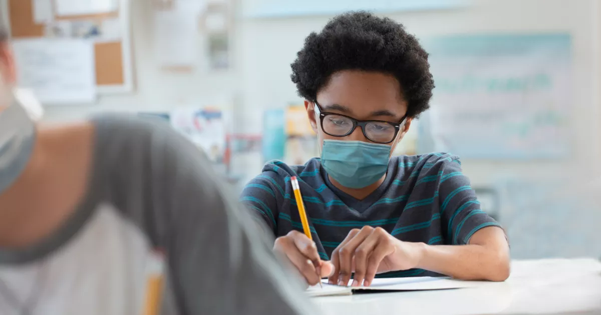 Student in Mask Taking a Test