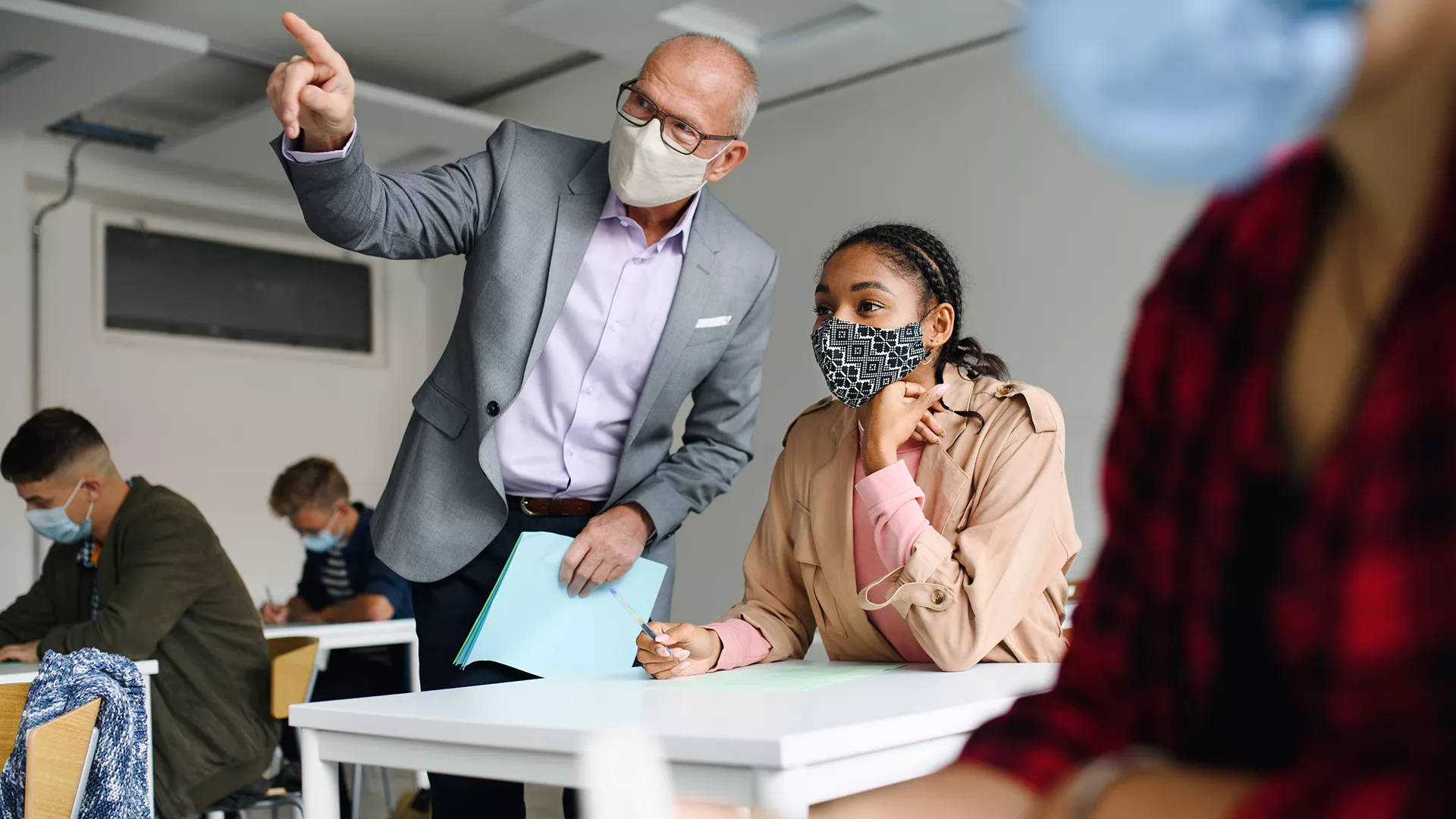 Higher ed professor explaining something to student