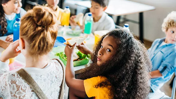 Children eat lunch in a school cafeteria