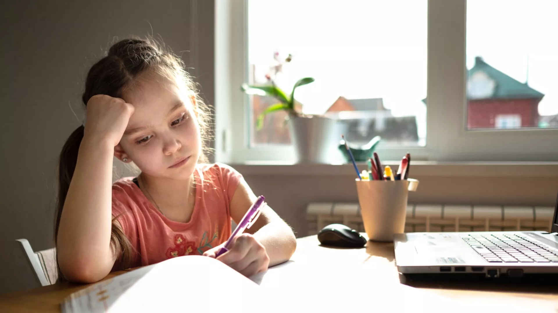 A girl studies at home