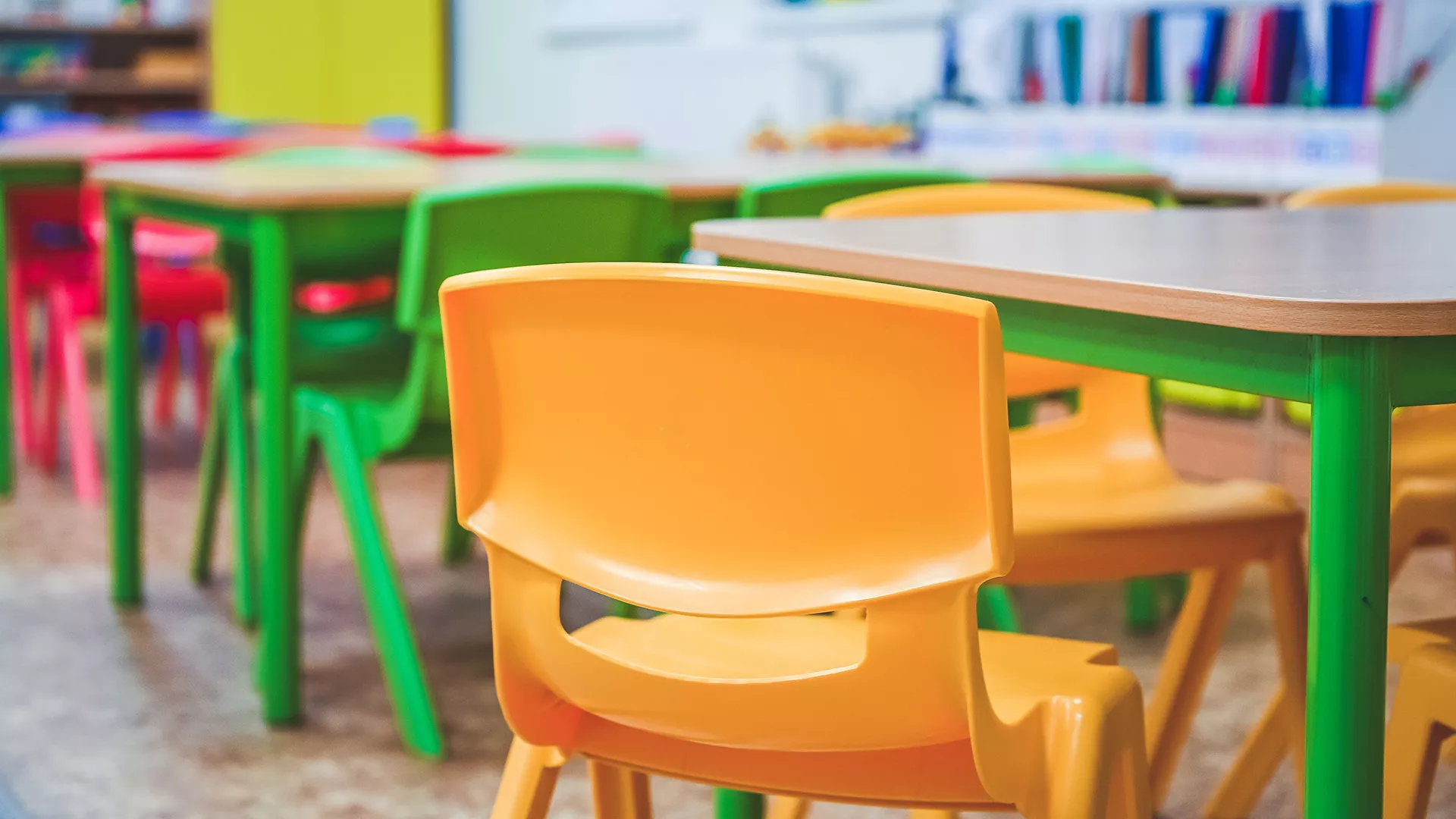 empty kindergarten classroom with yellow chairs