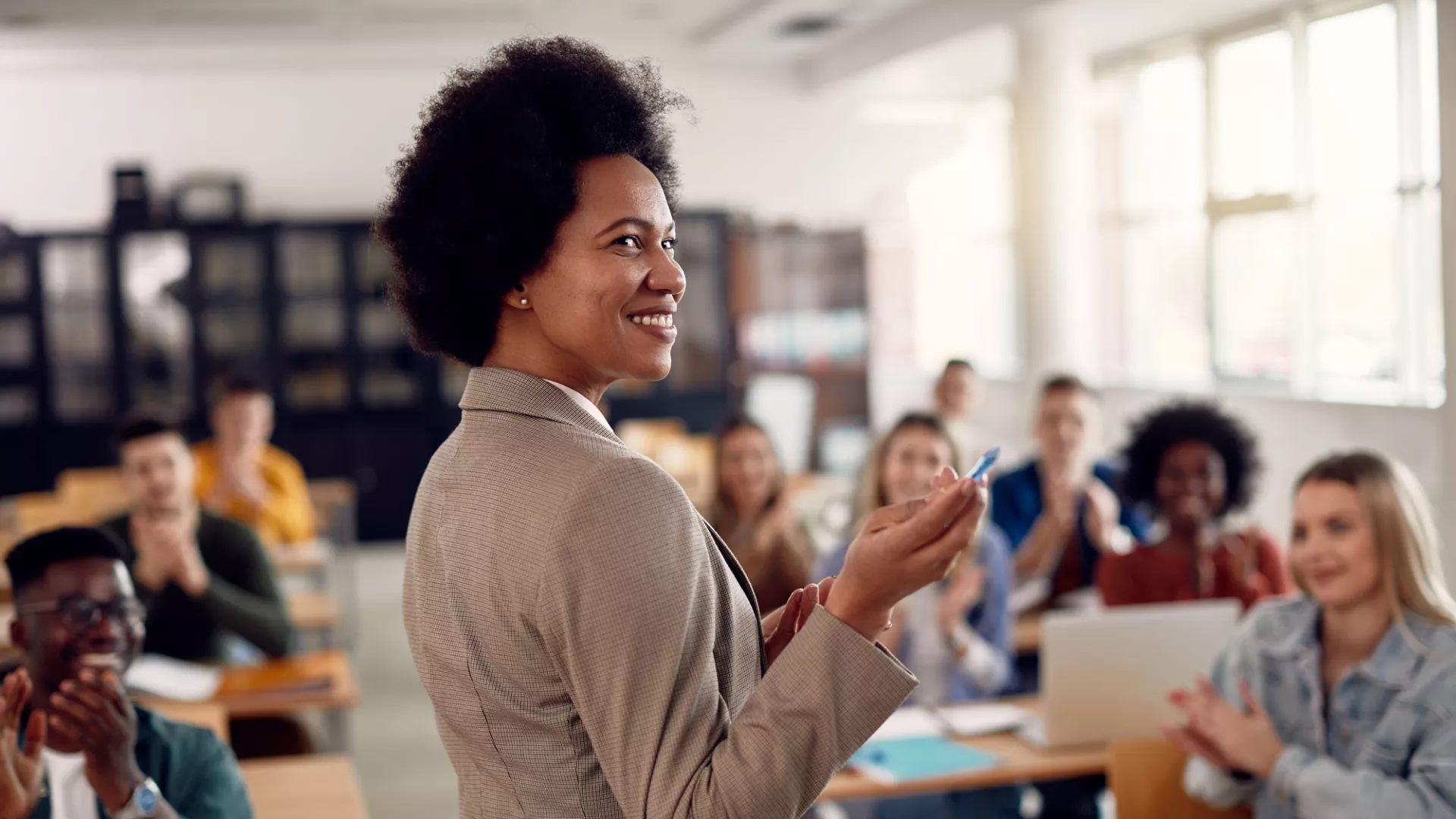 black woman teaches in a classoom