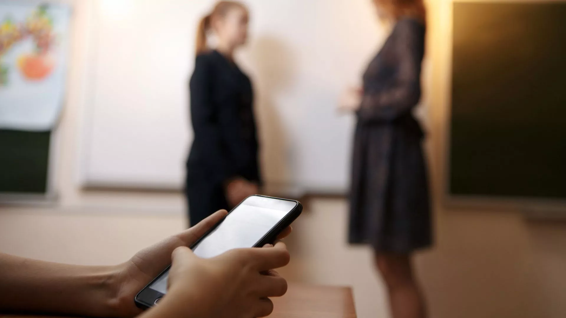 A cell phone with people in the distance