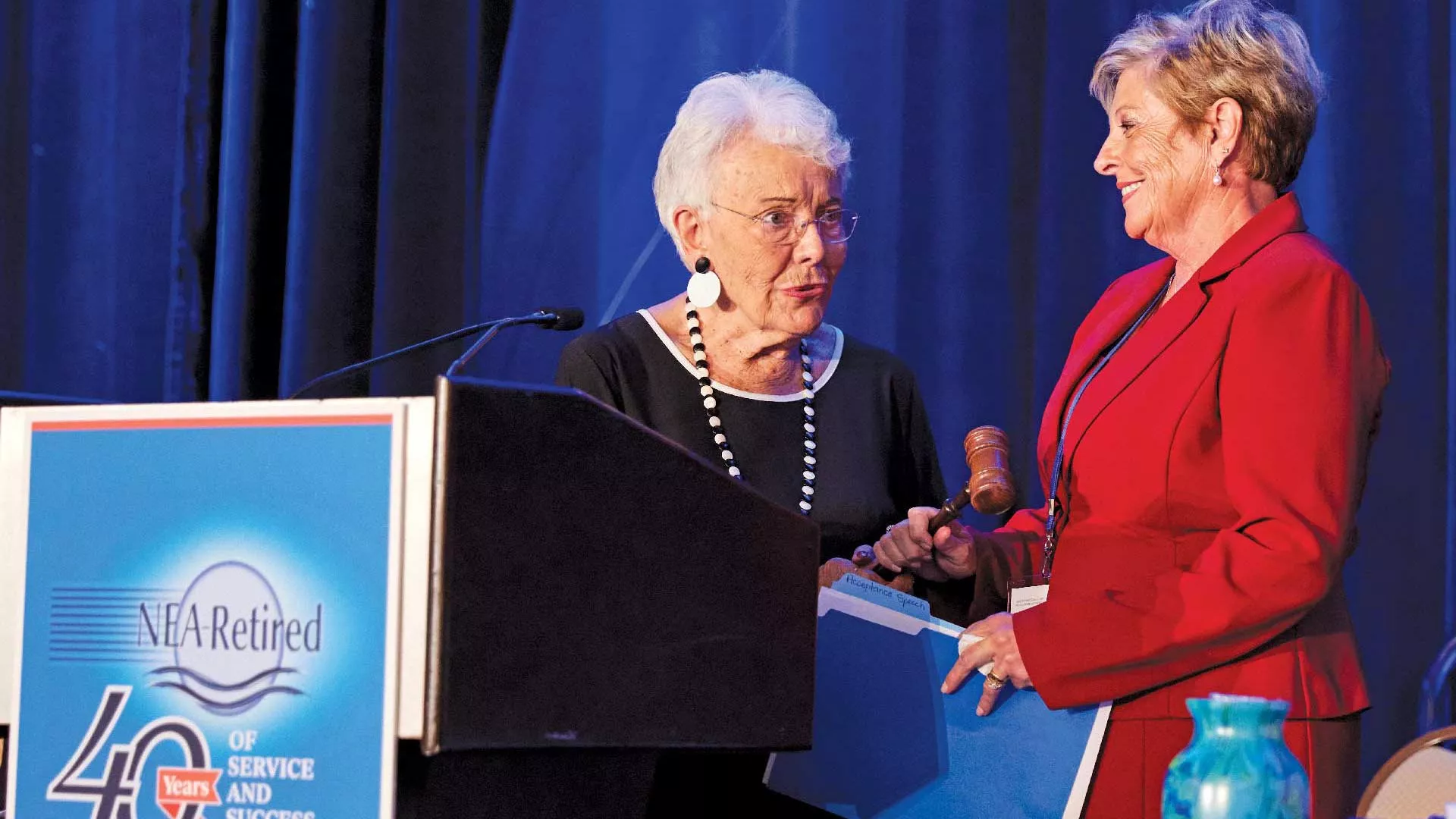 Former NEA-Retired President Sarah Borgman hands the ceremonial gavel to incoming NEA-Retired President Anita Gibson