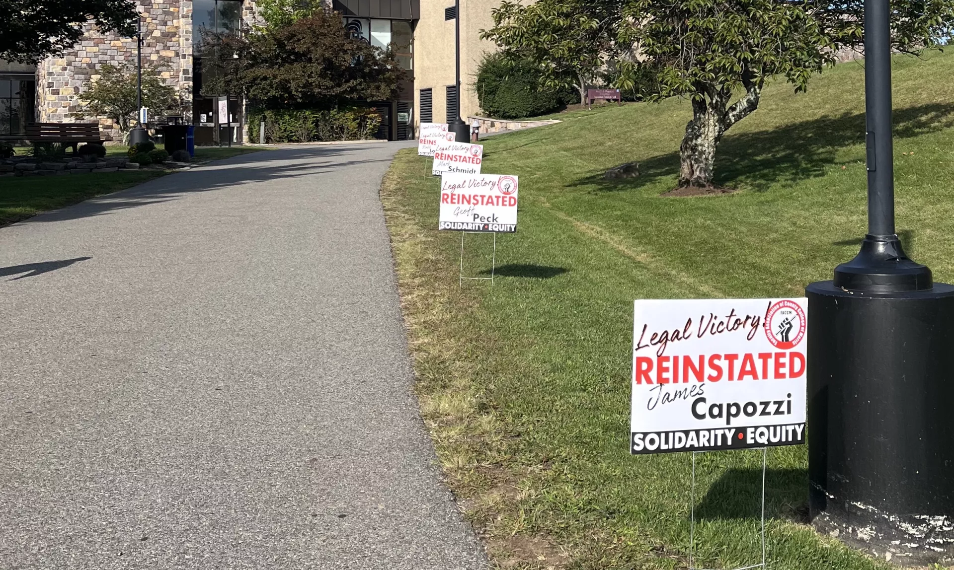 Photo of "reinstated" signs on CCM campus