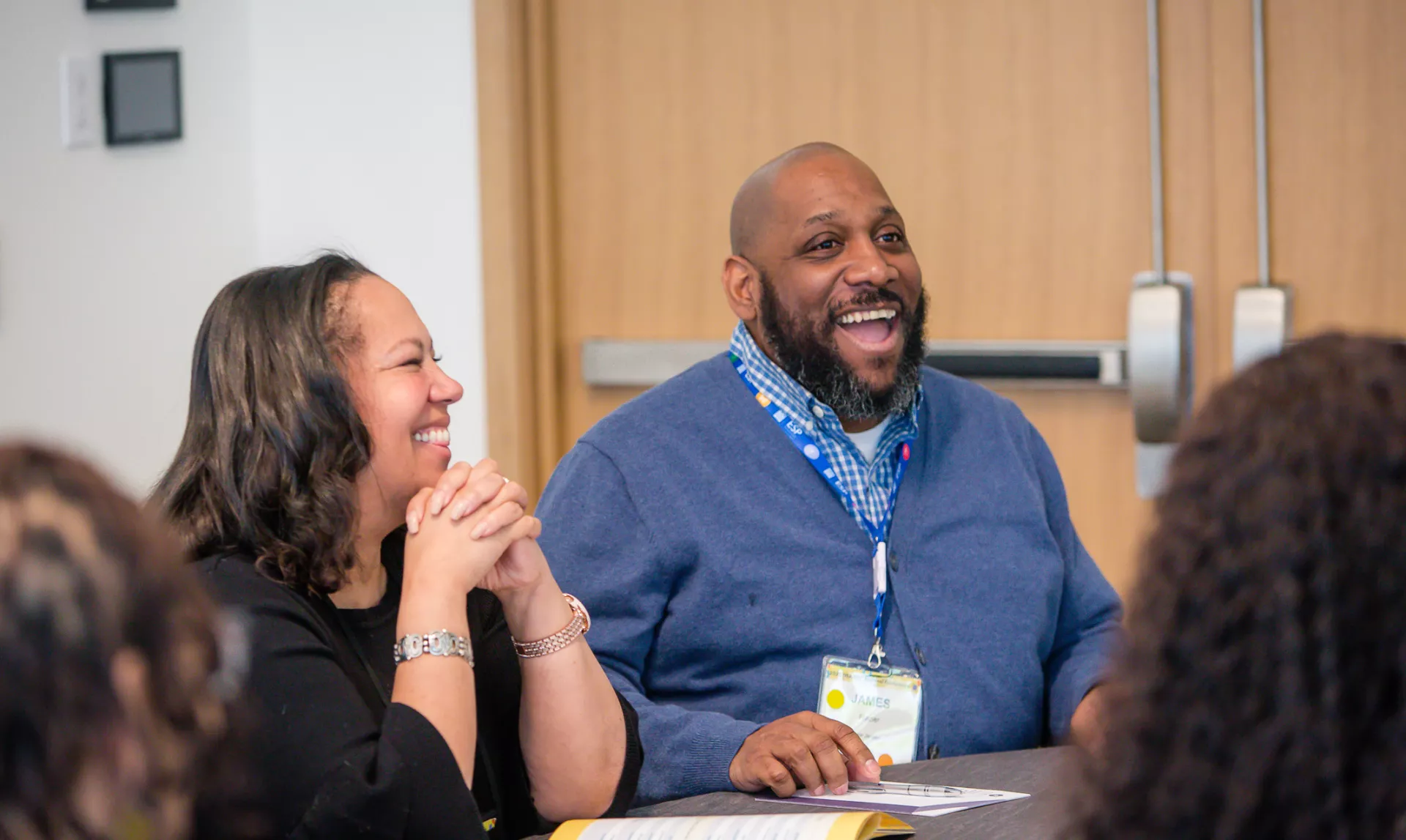 photo of an African American man and woman at a table networking