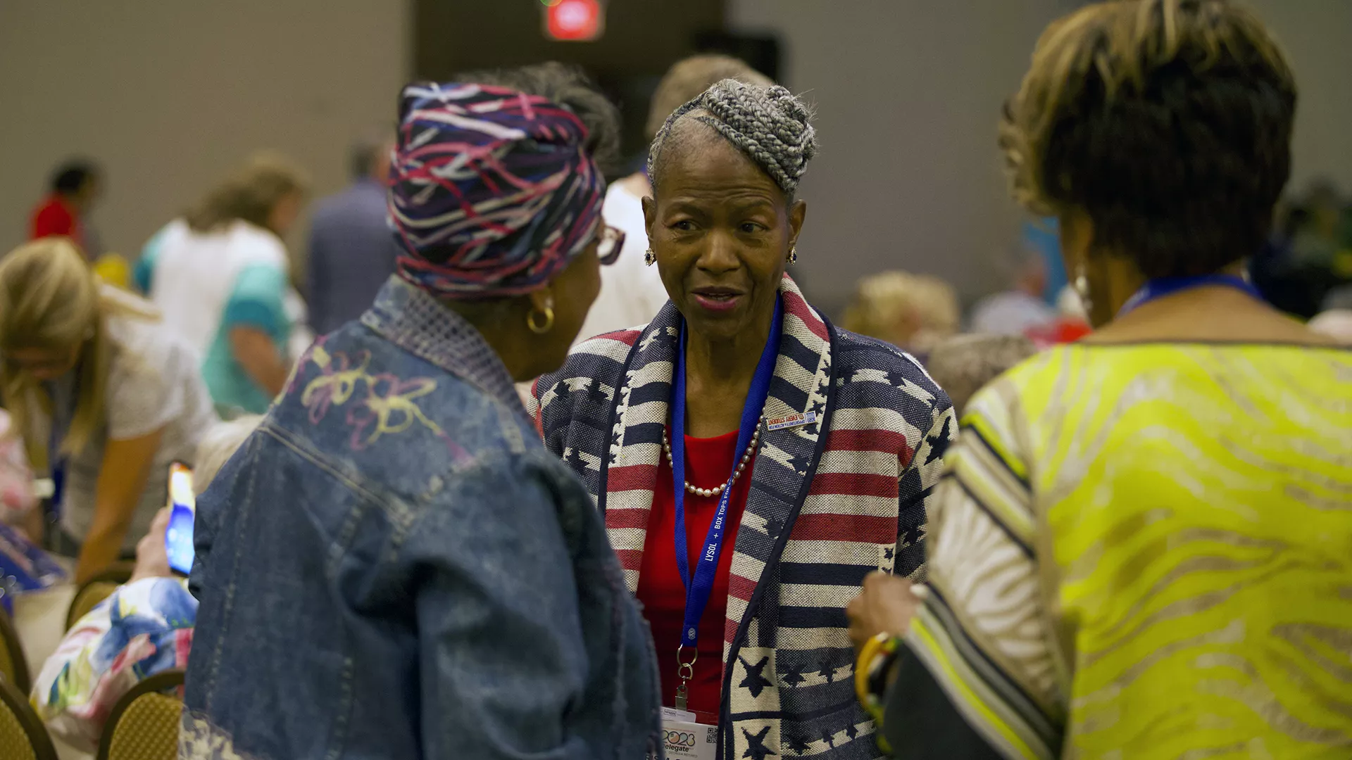 three attendees at the 2023 retired annual meeting speak together