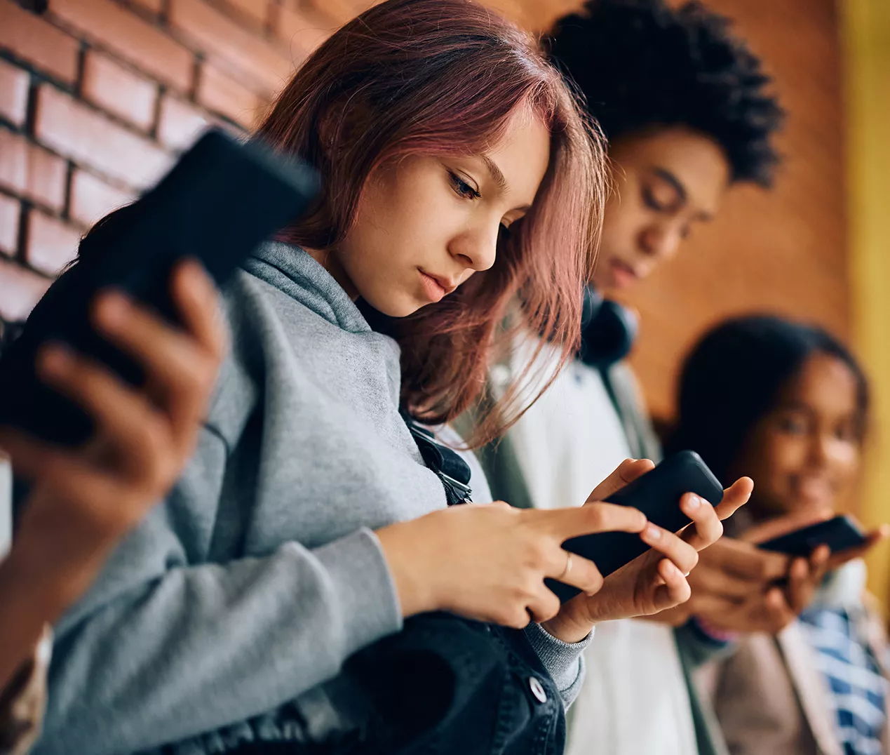 students on cell phones in hall