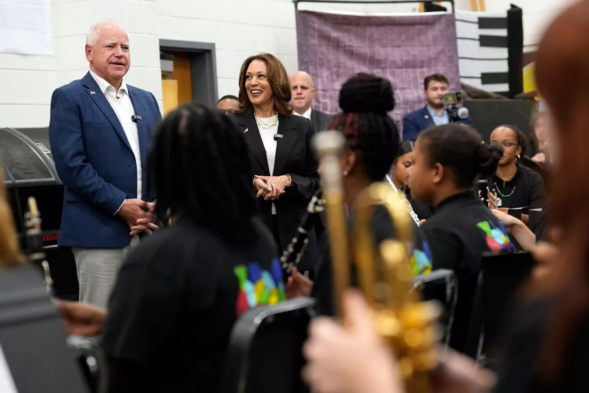 Kamala Harris and Tim Walz with a school band
