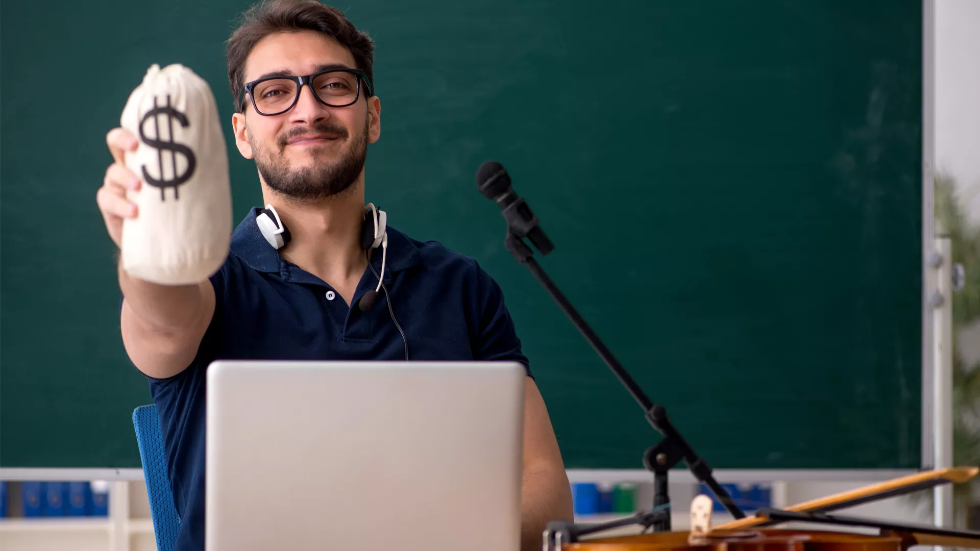 A man wearing glasses is holding a bag filled with money, showcasing a happy expression.