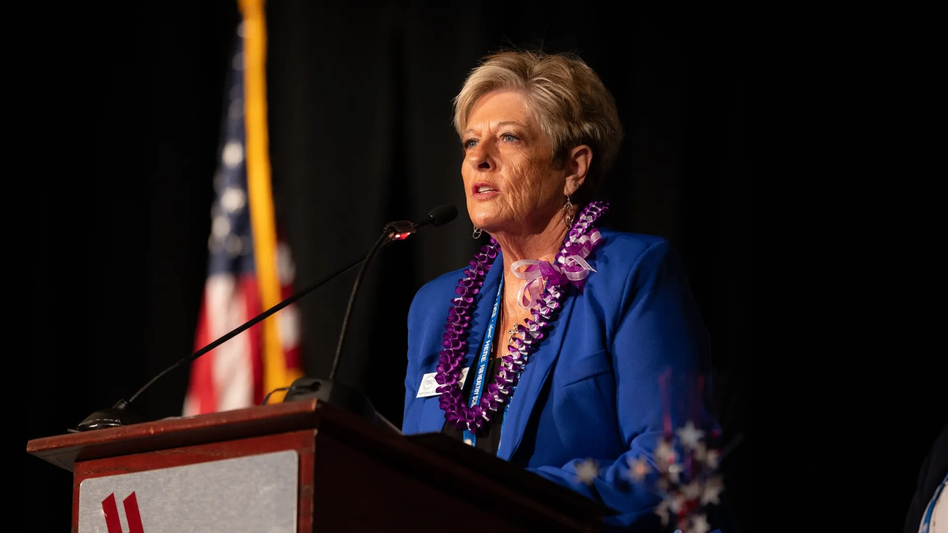 Anita Gibson speaking at podium
