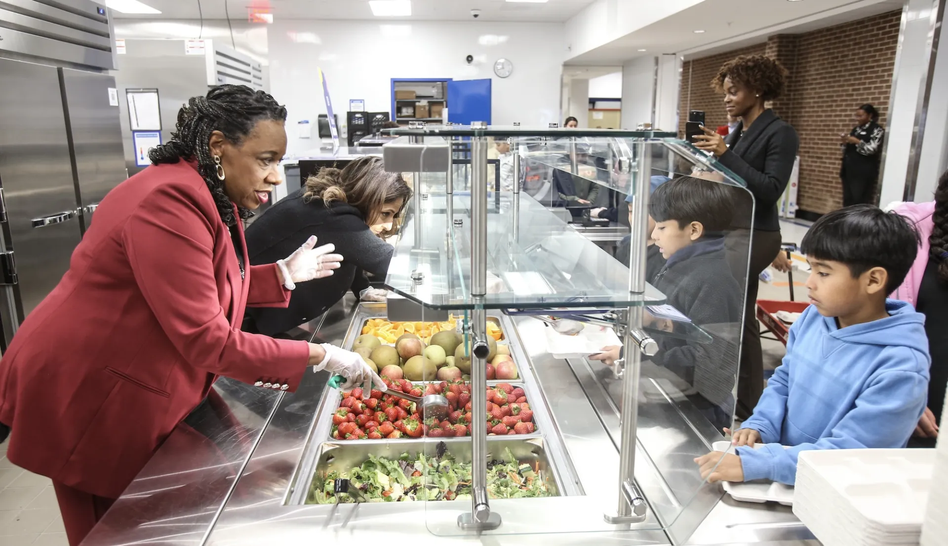 NEA President Becky Pringle serves students a hot lunch during American Education Week.