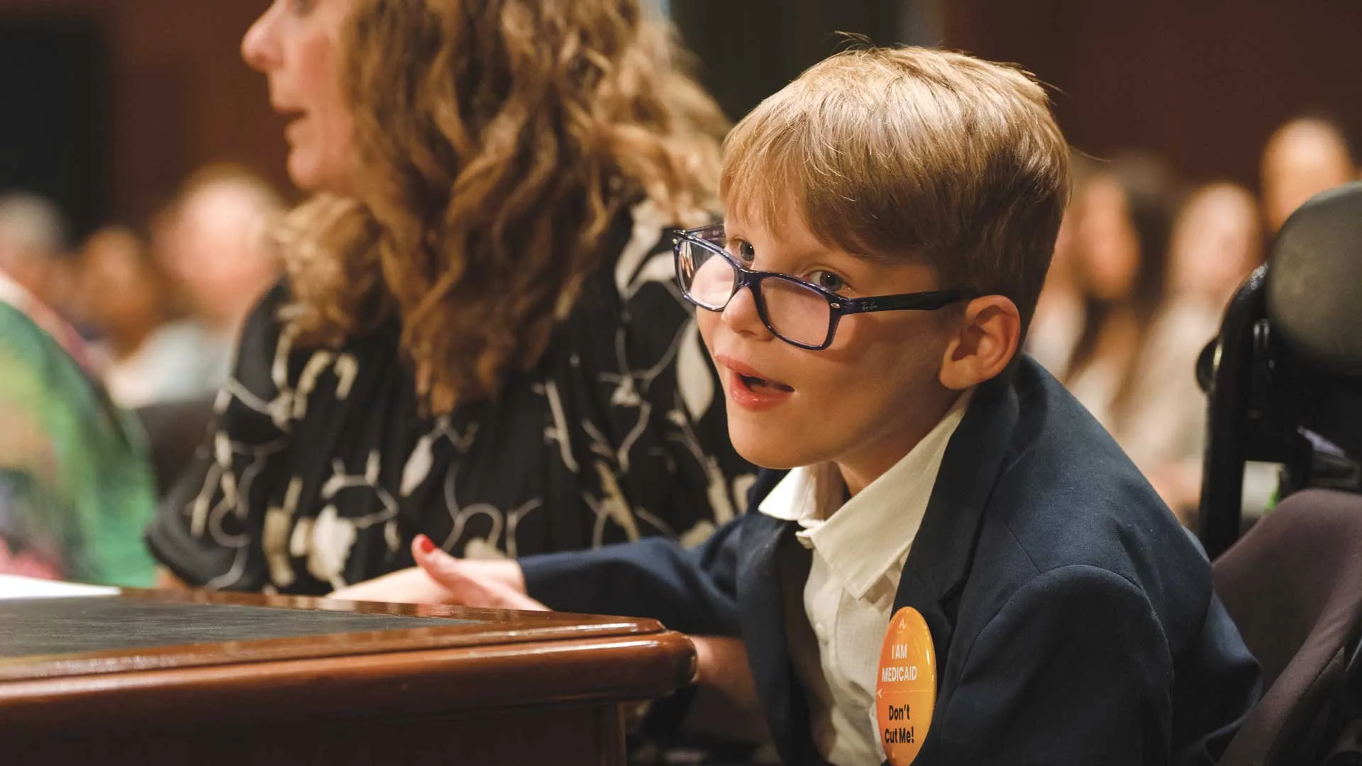 Nancy Baker Curtis, with her son, Charlie, speaks out against Medicaid cuts at a U.S. House of Representatives hearing. 
