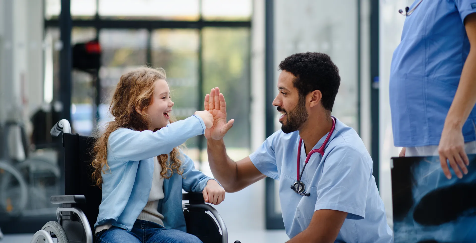 Child and doctor high-fiving