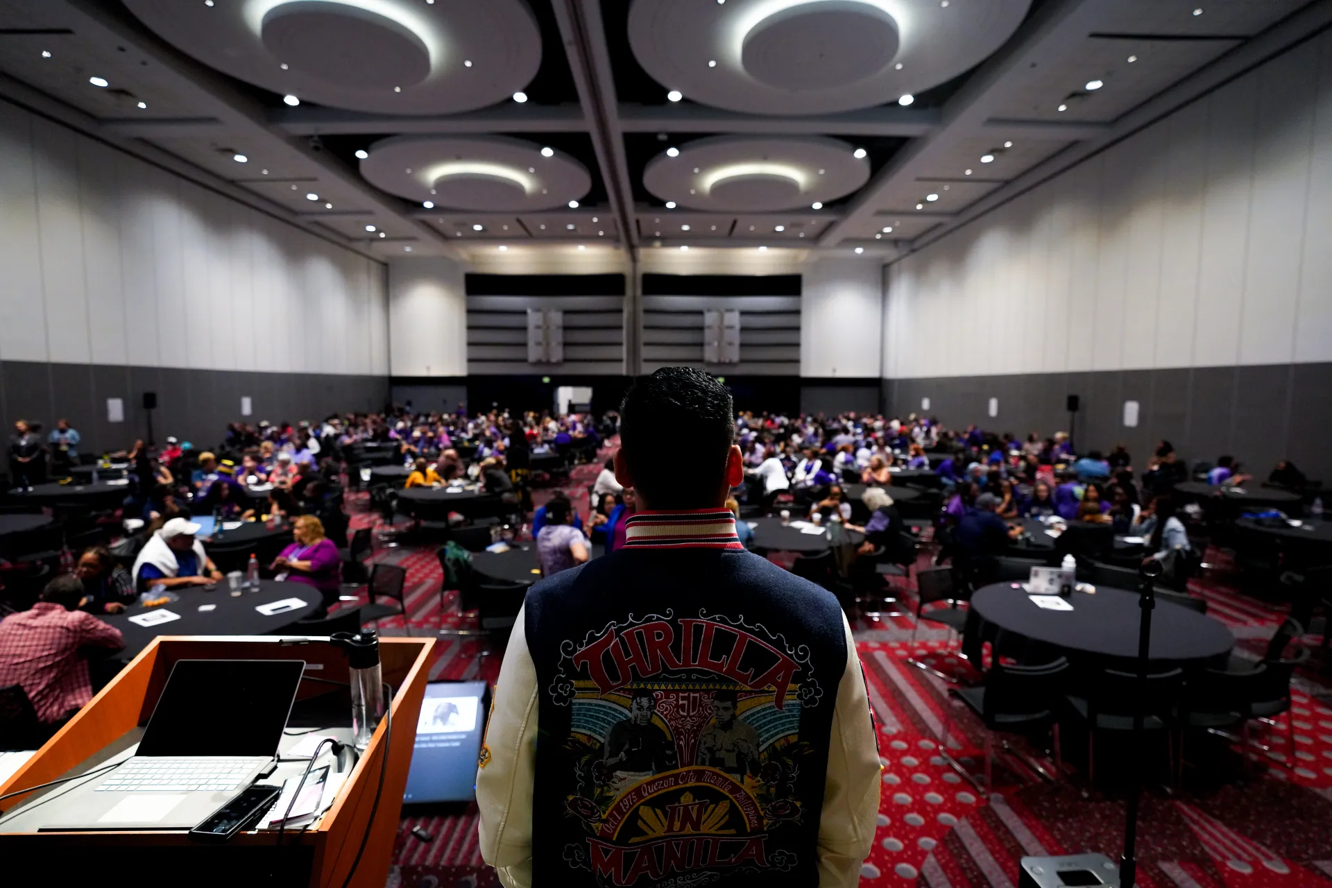 Back view of speaker, full room of RA delegates