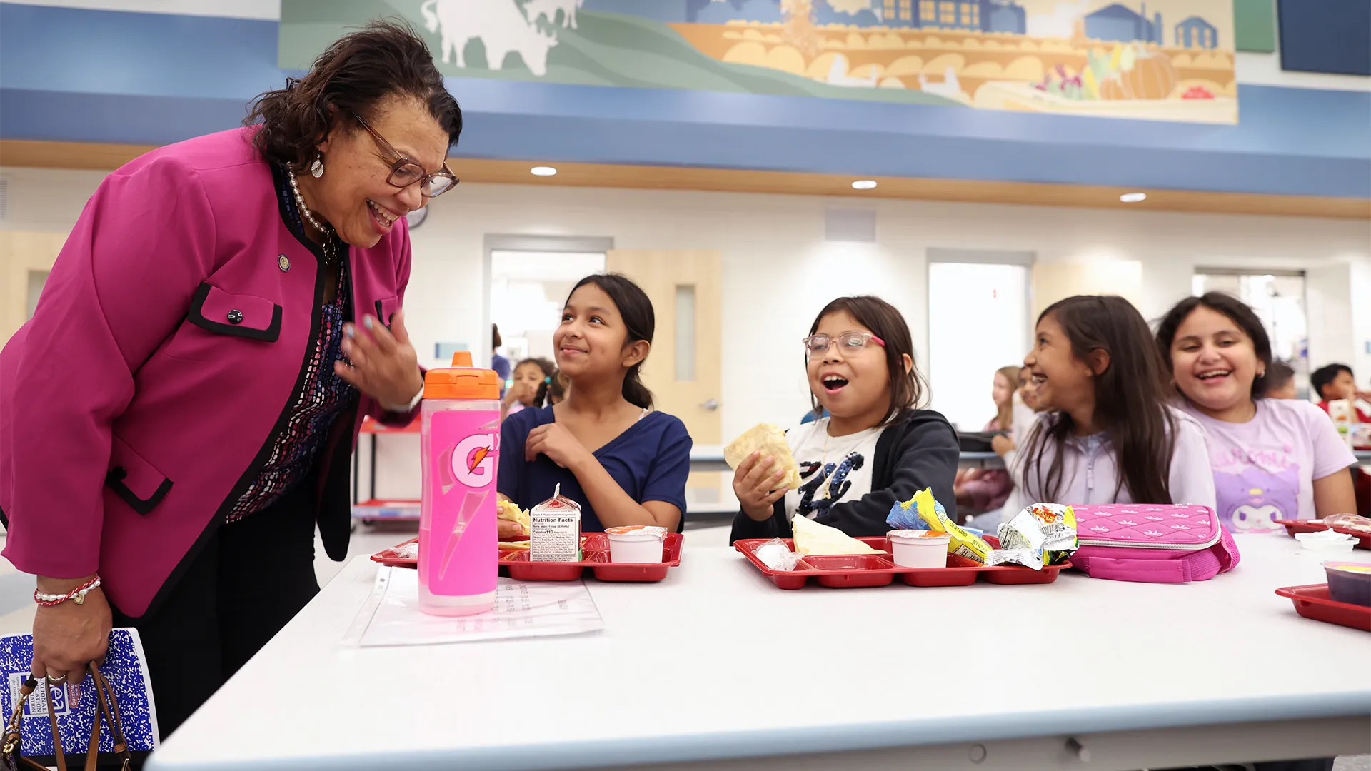 NEA President Princess Moss talks with female students in the school cafeteria