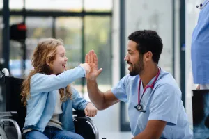 Child and doctor high-fiving