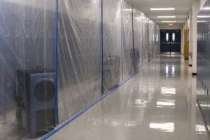 School corridor partitioned for mold treatment.