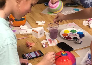 Holicong Middle School student paints a pumpkin