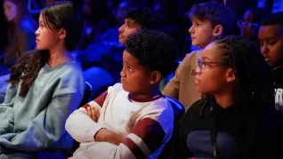 Students sit and watch a performance of The Crosssover