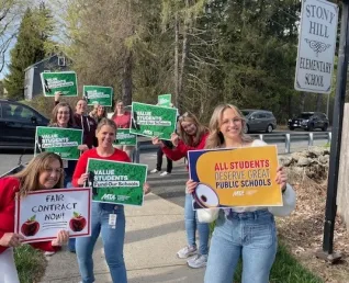 Mass teachers with signs