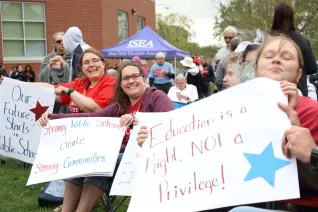 Iowa educators with signs