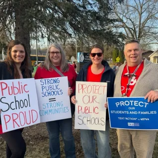 Michigan educators with signs