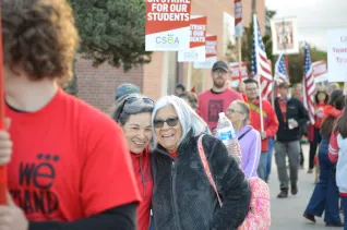 Educators embrace on the picket line