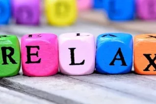 brightly colored cubes that spell out the word relax