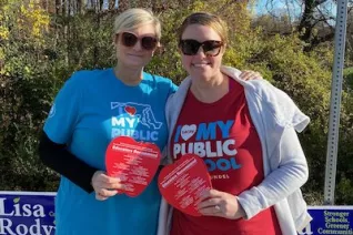 Maryland educators in pro-public education T-shirts distribute info before the election