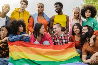 Group of students with rainbow flag