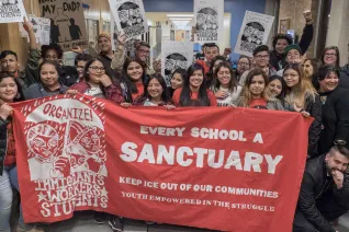 Students with an orange banner saying Every School a Sanctuary